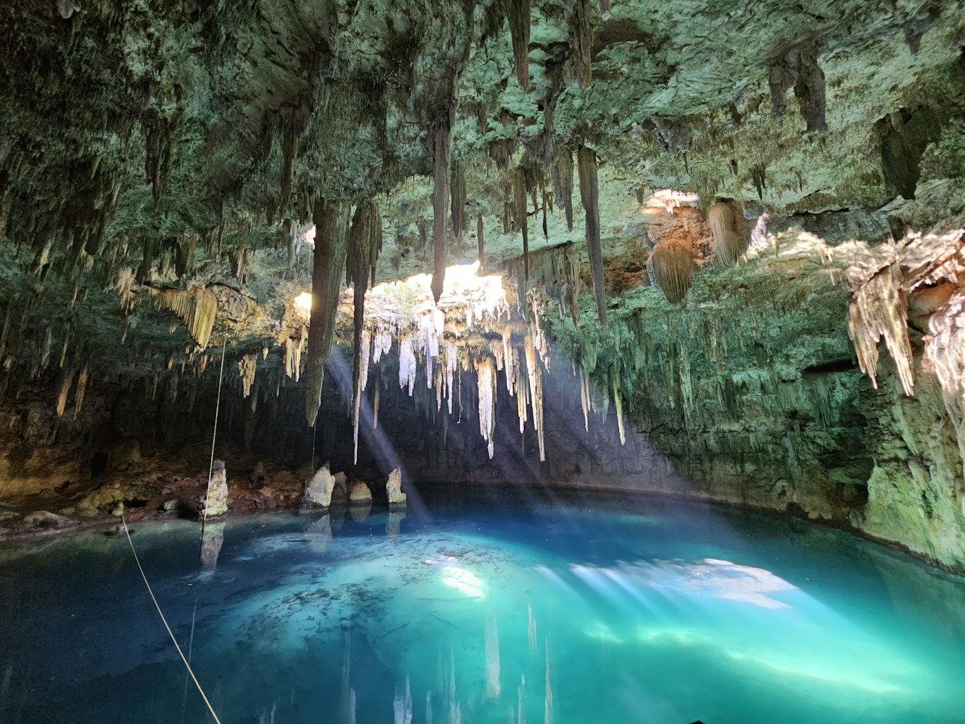 Stalactites hanging over a cave cenote