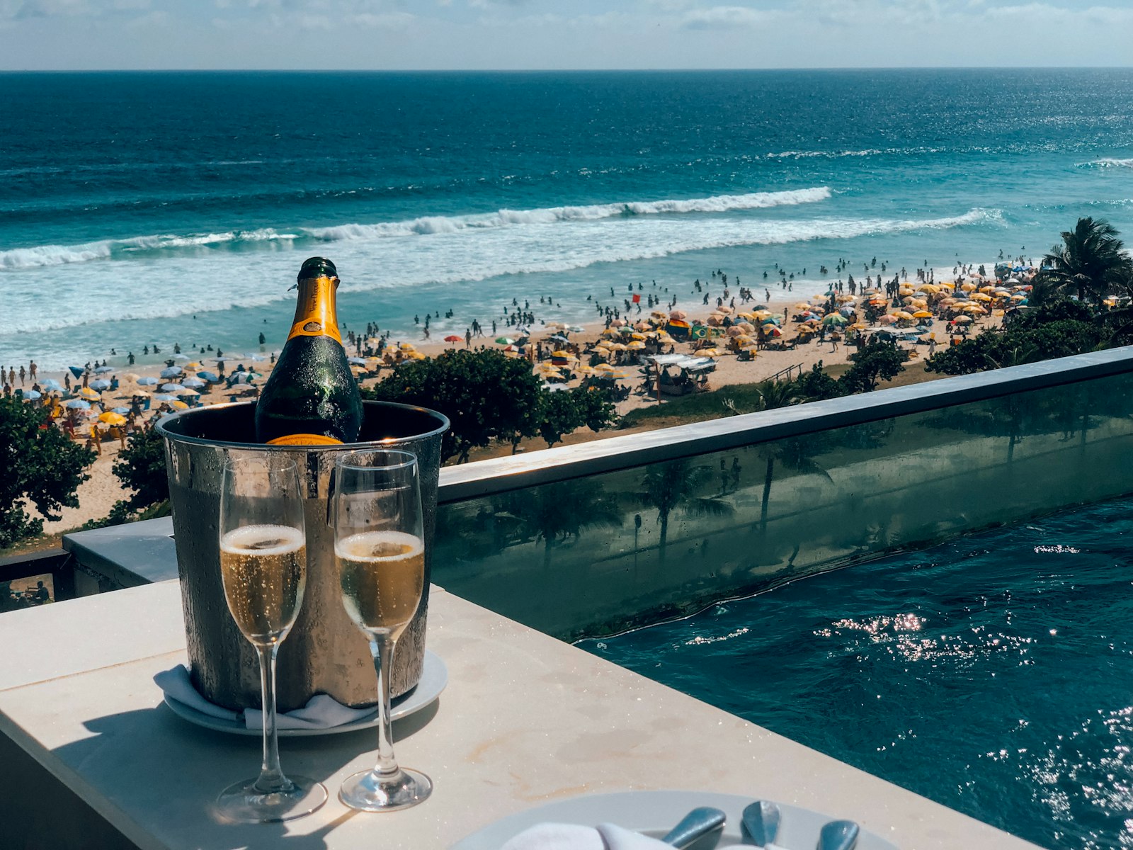 Champagne glasses beside a bottle