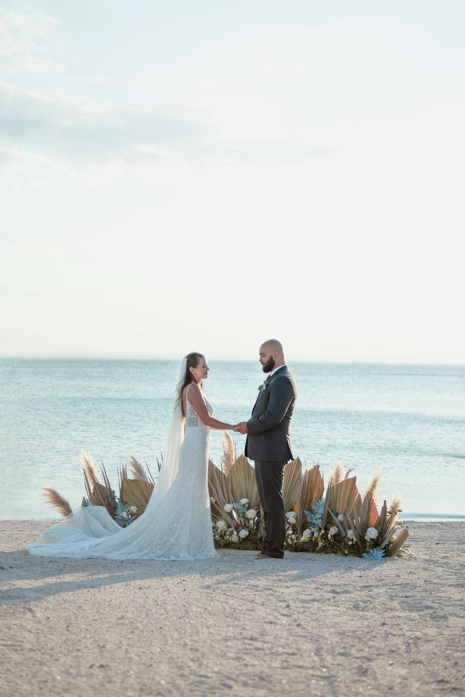 A couple holding hands on the beach